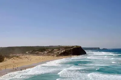 a group of people on a beach near the ocean at Az Villa Sea e Sun in Aljezur