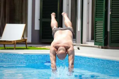 a man laying on his back in a swimming pool at Az Villa Sea e Sun in Aljezur