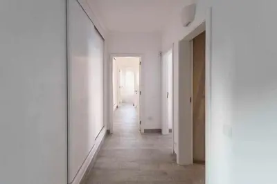 an empty hallway with white walls and a long corridor at Az Villa Sea e Sun in Aljezur