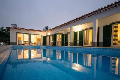 a villa with a swimming pool at night at Az Villa Sea e Sun in Aljezur