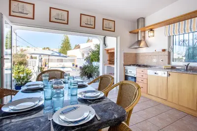 a table on a balcony with a view of a pool at Casa Bom Porto in Luz