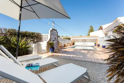 an aerial view of a beach with houses and the ocean at Casa Bom Porto in Luz