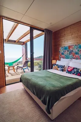 a bedroom with a bed and a large window at Calheta Glamping Pods - Nature Retreat in Calheta