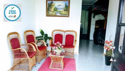 a group of wicker chairs and a table with flowers at Apartamentos Villa in Ponta do Sol