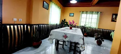 a dining room with a table with a white table cloth at Apartamentos Villa in Ponta do Sol
