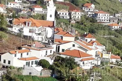 a group of white houses on a hill at Apartamentos Villa in Ponta do Sol