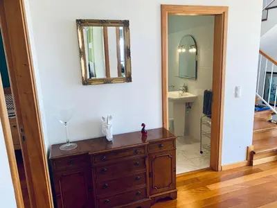 a bathroom with a dresser and a mirror on a wall at VILLA FELICIDADE in Arco da Calheta