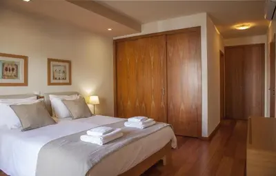 a bedroom with a large bed with towels on it at B27 - LuzBay 2 Bed Apartment in Luz