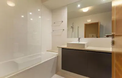 a bathroom with a sink and a tub and a mirror at B27 - LuzBay 2 Bed Apartment in Luz