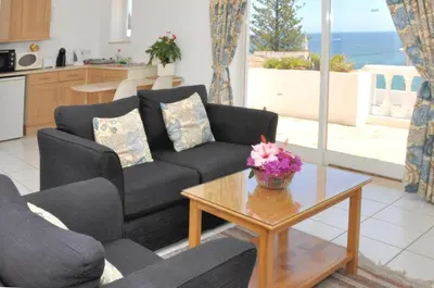 a living room with a couch and a table at Ocean Villas Luz in Luz