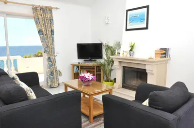 a living room with two couches and a fireplace at Ocean Villas Luz in Luz