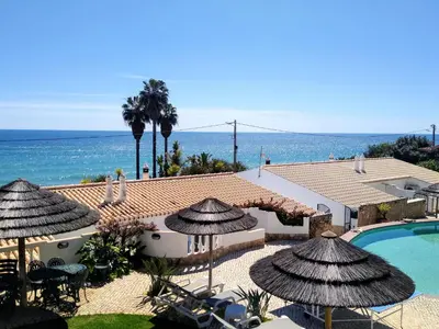 a resort with a swimming pool and the ocean at Ocean Villas Luz in Luz