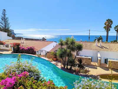 a swimming pool with a view of the ocean at Ocean Villas Luz in Luz