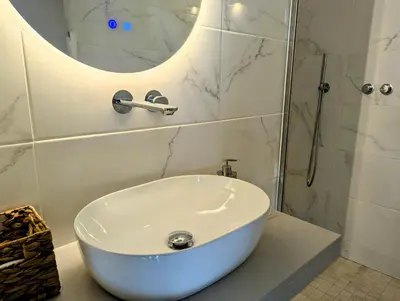 a bathroom with a white sink and a mirror at Ocean Villas Luz in Luz