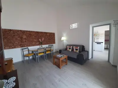 a living room with a table and a couch at Quinta do Maranhão in Lagos