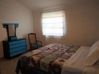 a bedroom with a bed and a vase of flowers on a table at Quinta do Maranhão in Lagos