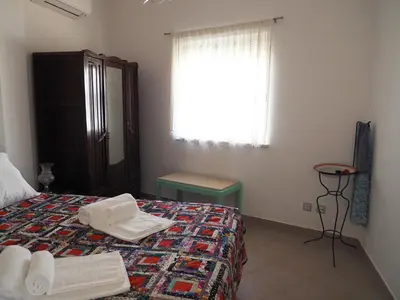 a bedroom with two twin beds and a table at Quinta do Maranhão in Lagos