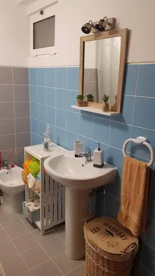 a bathroom with a sink and a mirror and a toilet at Atlantis Flat. Relaxing Moments in Machico