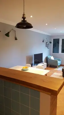 a kitchen with a island in a living room at Atlantis Flat. Relaxing Moments in Machico