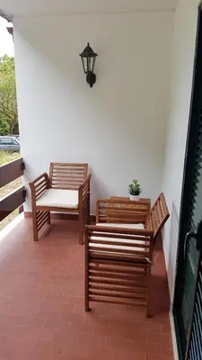 two benches sitting on a porch with a lamp at Atlantis Flat. Relaxing Moments in Machico