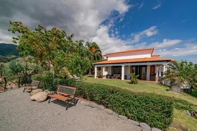 a house with a bench in front of it at Southern Sunny House by An Island Apart in Calheta