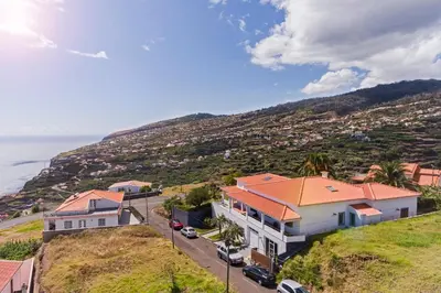 a house on a hill next to the ocean at Southern Sunny House by An Island Apart in Calheta