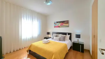 a bedroom with a bed with two towels on it at Casa Silvana in Caniço