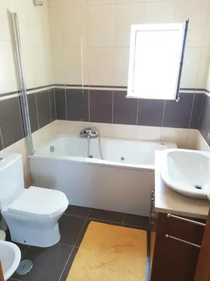 a bathroom with a tub and a toilet and a sink at Casa Luminosa in Carrapateira