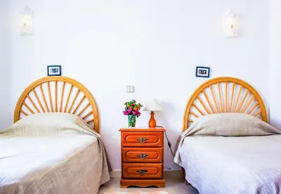 a living room with a blue couch and a table at 38, Vila Gaivota in Luz