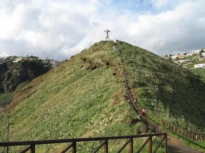 a hill with a cross on top of it at Vista Mar - Modern Sea Views In Caniço de Baixo in Caniço