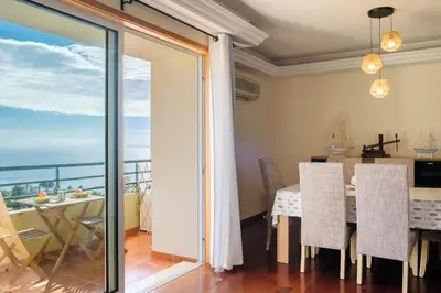 a dining room with a view of the ocean at Vista Mar - Modern Sea Views In Caniço de Baixo in Caniço