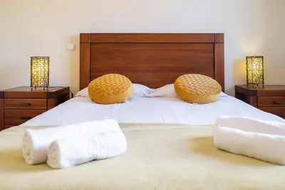 a bedroom with a bed with two towels on it at Vista Mar - Modern Sea Views In Caniço de Baixo in Caniço