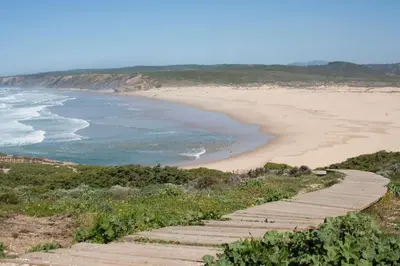 a stairway leading down to a sandy beach at Casa Bombordo in Carrapateira