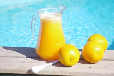 a jug of orange juice next to some lemons at Russo Surf Resort - Vale Figueiras in Aljezur