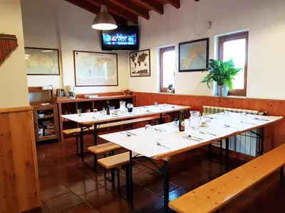 a row of tables in a restaurant with a tv at Russo Surf Resort - Vale Figueiras in Aljezur