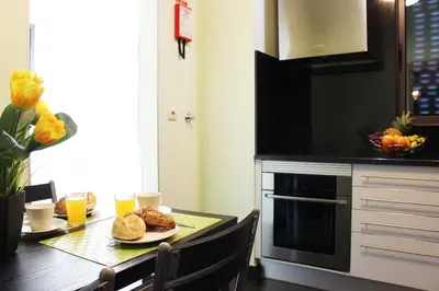a kitchen with a table with a plate of food at MCStylo-Residenza in Funchal