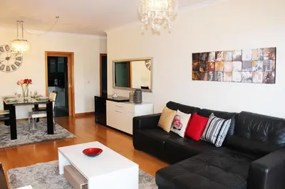 a living room with a black couch and a table at MCStylo-Residenza in Funchal