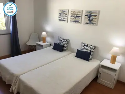 a bedroom with two beds and a window at Casa Maré in Sagres