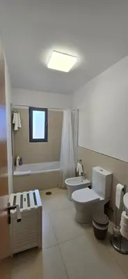 a bathroom with a toilet and a bath tub at Casa da Praia in Calheta