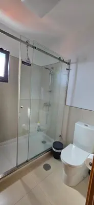 a bathroom with a glass shower and a toilet at Casa da Praia in Calheta