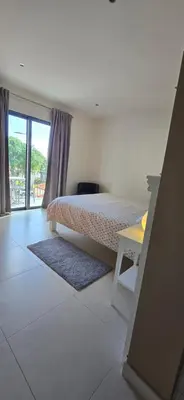 a bedroom with a bed and a desk and a window at Casa da Praia in Calheta