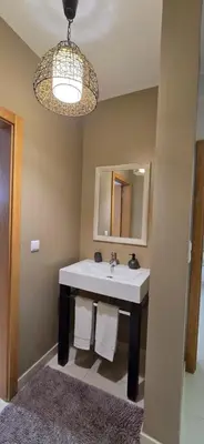 a bathroom with a sink and a mirror at Casa da Praia in Calheta