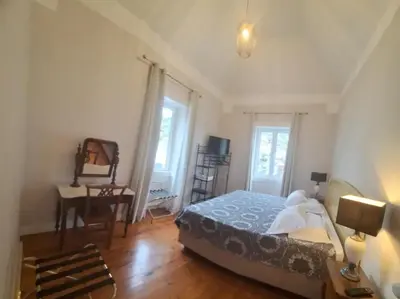 a living room with a couch and a table and chairs at Valentina's House in Porto da Cruz