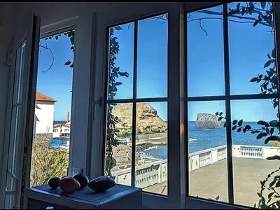 a microwave sitting on a counter in front of a window at Valentina's House in Porto da Cruz