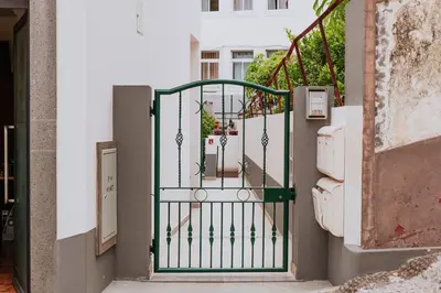 a gate on a stairway with a building at Vila Mar Apartment in Ponta do Sol