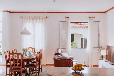 a dining room with a table and chairs at Vila Mar Apartment in Ponta do Sol