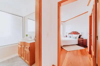 a bedroom with a mirror and a bed and a sink at Vila Mar Apartment in Ponta do Sol