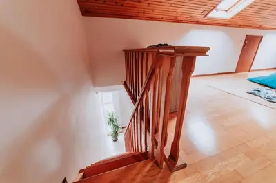 a wooden staircase in a room with a wooden ceiling at Vila Mar Apartment in Ponta do Sol
