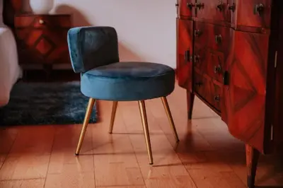 a blue chair sitting next to a dresser at Vila Mar Apartment in Ponta do Sol