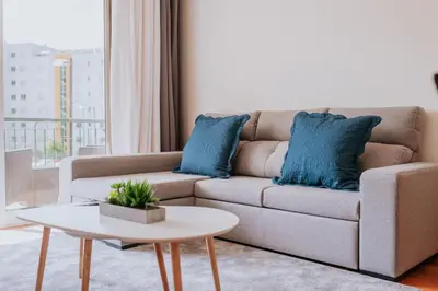 a living room with a couch with blue pillows at Funchal Lounge Apartment II by Amazing Madeira in Funchal